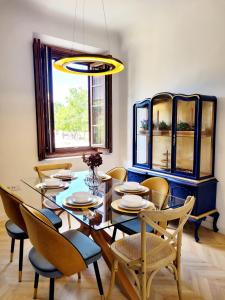 a dining room with a blue table and chairs at Casa Rístori Mirador in Manzanares