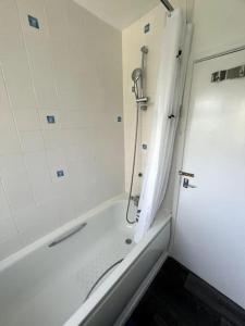 a bathroom with a shower and a bath tub at Serene Escape in Monmore Green