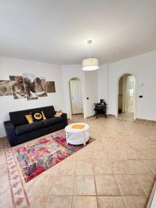 a living room with a couch and a table at LA Home - Animal House in Viareggio