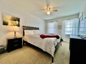 a bedroom with a bed and a ceiling fan at Worley's House in Rockdale