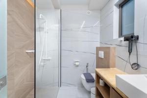 a bathroom with a shower and a toilet at Ennea Muses Rooms and Suites in Nafplio