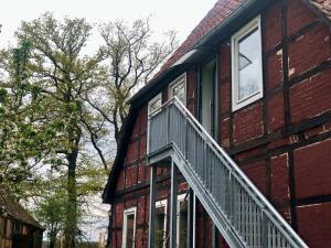 a brick house with a staircase on the side of it at Hof KuMa in Uelzen