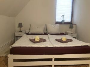 a bedroom with a large bed with two pillows on it at Hof KuMa in Uelzen