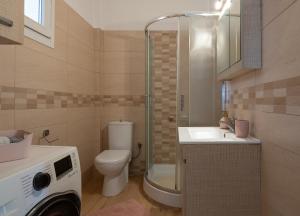 a bathroom with a toilet a sink and a shower at Lakis House Nikiti in Nikiti +30 photos