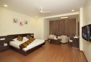 a bedroom with a bed and a flat screen tv at Best Western Swing High Katra in Katra