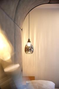 a light hanging from a wall in a room at Hotel Gasthof Siggen in Neukirchen am Großvenediger