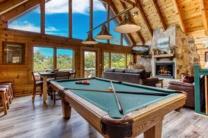 a pool table in a room with a fireplace at City View Chalet in Gatlinburg