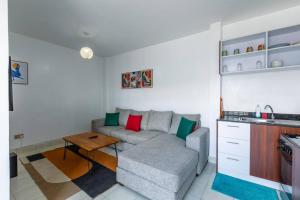 a living room with a couch and a table at Cosy Nest cribs Nairobi in Nairobi