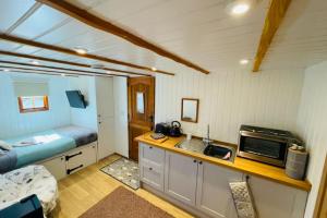 a small room with a kitchen and a sink at Shepherds Hut, West Ayton, Scarborough in Scarborough