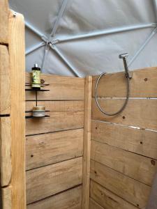 a wooden wall with a hose on it in a tent at Glamping ROSE (Luštica Bay) in Radovici