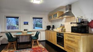 a kitchen with a table and a stove top oven at Stadt-Ferienwohnung mit 55 m² für 2 erw. Personen und Kind bis 3 Jahren in Bad Lauterberg
