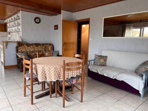 a living room with a table and a couch at Maison Brem-Sur-Mer in Brem-Sur-Mer