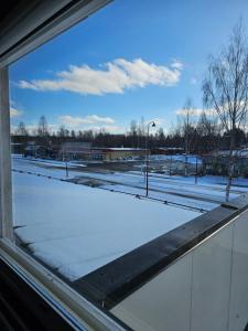 a window view of a snow covered parking lot at Majoitus Kulma in Ilomantsi