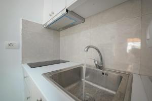 a kitchen with a sink with a faucet at Guest House Moonlight in Ksamil +131 photos
