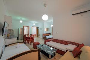 a living room with a couch and a table at Guest House Moonlight in Ksamil