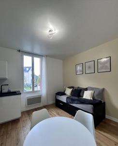 a bedroom with a bed and a table and a window at T2 Pyrénéen in Pierrefitte-Nestalas