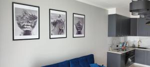 um grupo de quatro fotografias numa parede de uma cozinha em Fox Apartament Free parking em Bolesławiec