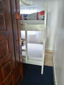 a bunk bed in a room with a door at Kai Suites Kitale in Kitale