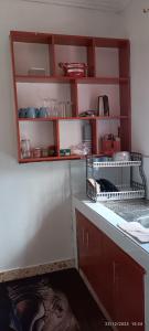 a kitchen with red cabinets and a counter top at Kai Suites Kitale in Kitale