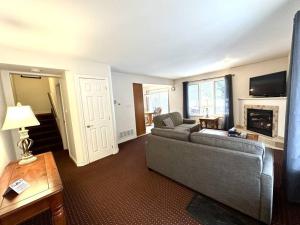 a living room with a couch and a fireplace at Family Vacation Hub in Collingwood