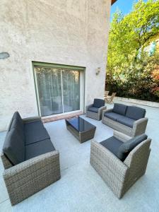 a patio with two couches and a table at Villa Victoria : Clim - Garage / 8 pers au Calme in Roquebrune-Cap-Martin