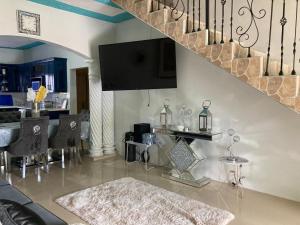 a living room with a staircase and a dining room at Blissful Retreat in Gravel Hill 