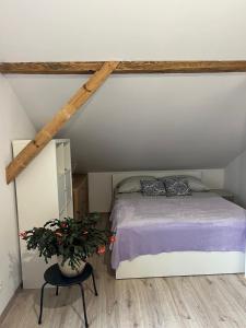 a bedroom with a bed in a attic at Lawendowa Sonata in Nowe Miasto