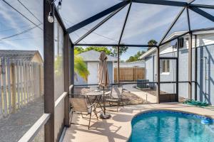 a patio with a pool and a table and chairs at South Daytona Home Game Room, Private Pool and Spa! in South Daytona