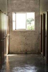 an empty room with a window and an open door at COOLFREEDIVING Hostel in Green Island