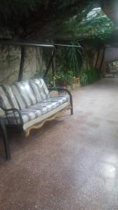 a metal bench sitting in a parking lot at شقه مفروشه مع حديقه اربد بجانب مدارس دار العلوم in Irbid