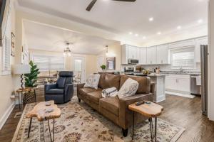 a living room with a couch and a kitchen at Highlands Home With Garage in Louisville