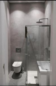 a bathroom with a shower and a toilet and a sink at Privilege Suite Pieta in Tal-Pietà