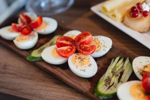 a plate of deviled eggs and vegetables on a table at Privilege Suite Pieta in Tal-Pietà