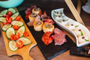 a plate of food with meats and vegetables on a table at Privilege Suite Pieta in Tal-Pietà