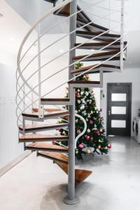 a spiral staircase with a christmas tree in a room at Privilege Suite Pieta in Tal-Pietà