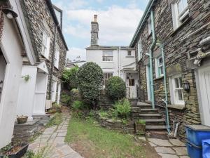 an alleyway between two houses with a tower at Springwell Cottage in Ambleside