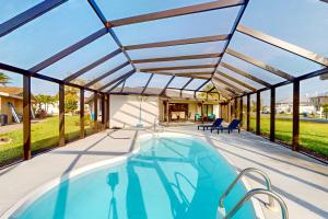 a swimming pool in a house with a roof at Sunrise Bay Escape in Fort Myers Beach