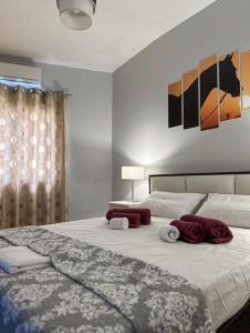 Menetaí的住宿－Harmony Heights apartment，一间卧室配有一张大床和毛巾