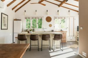 a kitchen with a large kitchen island with stools at Villa Estelle, Hvar Island in Vrbanj