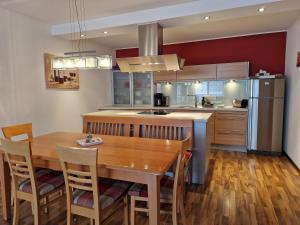 a kitchen with a wooden table and a dining room at Apartment Lamtana in Ischgl