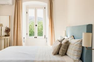 a bedroom with a bed with a window at Villa Estelle, Hvar Island in Vrbanj