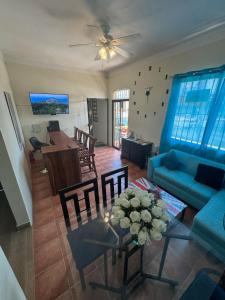 ein Wohnzimmer mit einem blauen Sofa und einem Tisch in der Unterkunft El Conde De Atrini in Santo Domingo