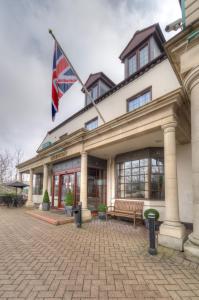 a building with a flag on top of it at Bridge House Hotel in Birmingham