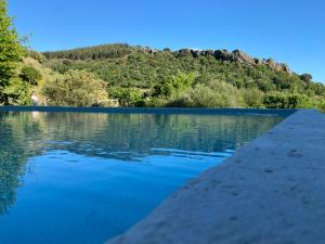 a body of water with a mountain in the background at Colmeal Countryside Hotel in Figueira de Castelo Rodrigo