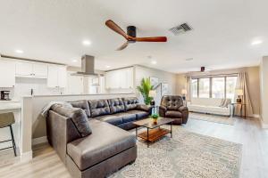 a living room with a couch and a ceiling fan at Sunrise Bay Escape in Fort Myers Beach