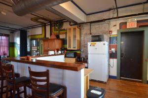 a kitchen with a counter and a refrigerator at Michie Hostel in Providence