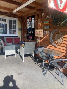 a patio with a table and chairs in a cabin at Private en-suite RUTHIN in Llanfair-Dyffryn-Clwyd