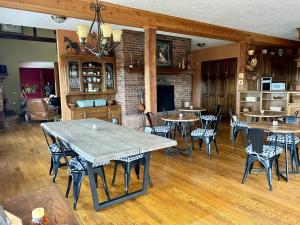 a dining room with tables and chairs and a fireplace at Warner-Concord Farms Bed & Breakfast in Geneva