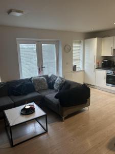 a living room with a couch and a table at Inviting 2-Bed Apartment in Bushey in Bushey