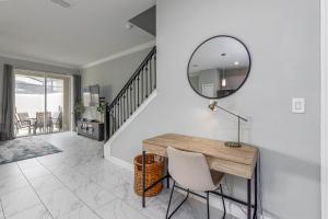 a dining room with a table and a mirror at TVPM-4263PD SL townhouse in Kissimmee